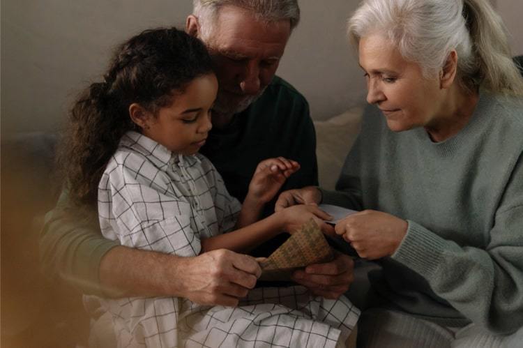 Grandparents and child reading a book